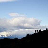 The silhouettes of hikers in the mountains of Patagonia.