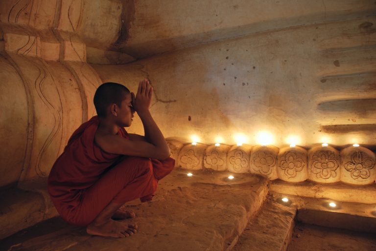 Buddhist monk praying inside the temple