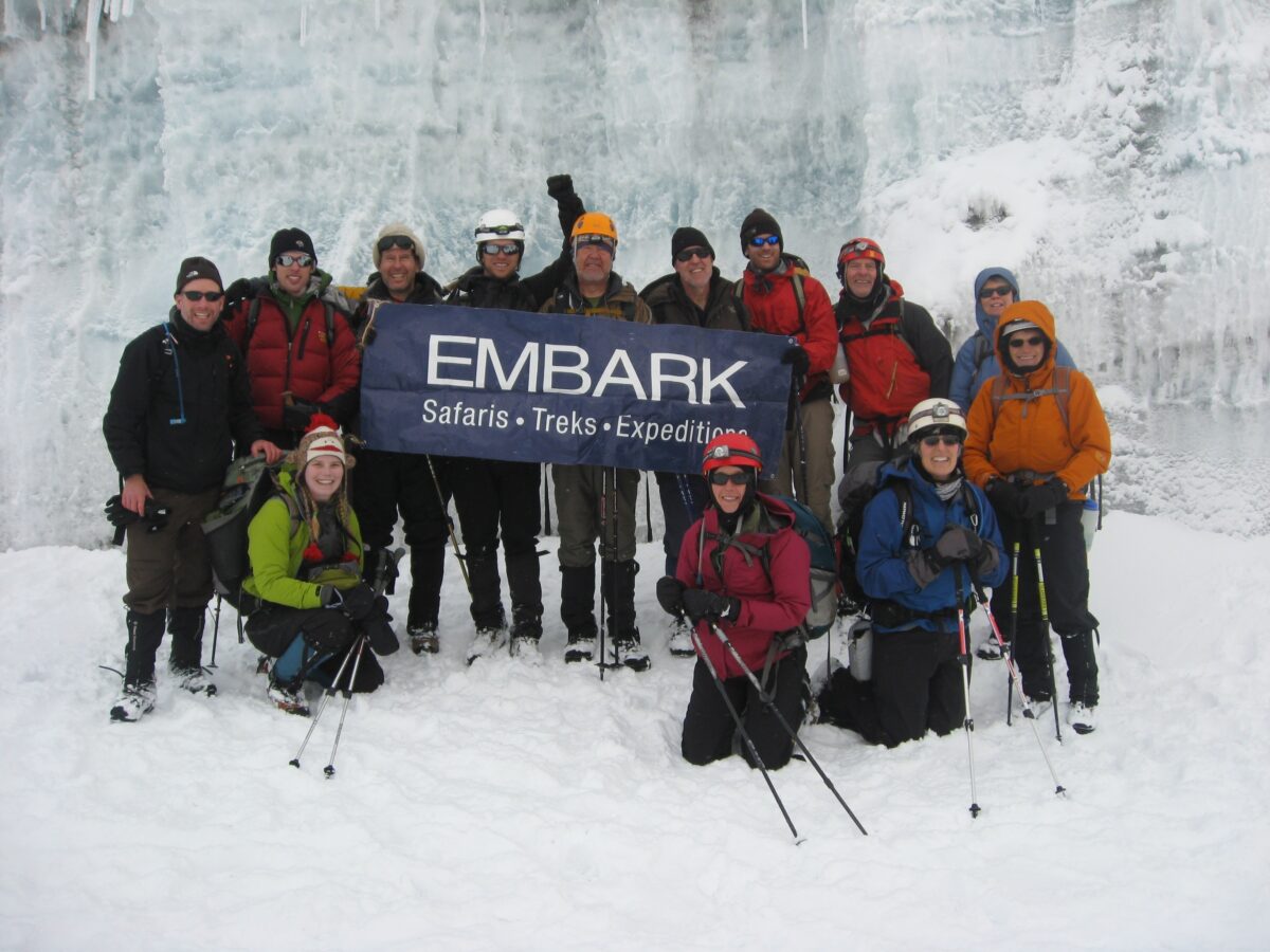 Experienced hikers on rocky trail with summit in the distance
